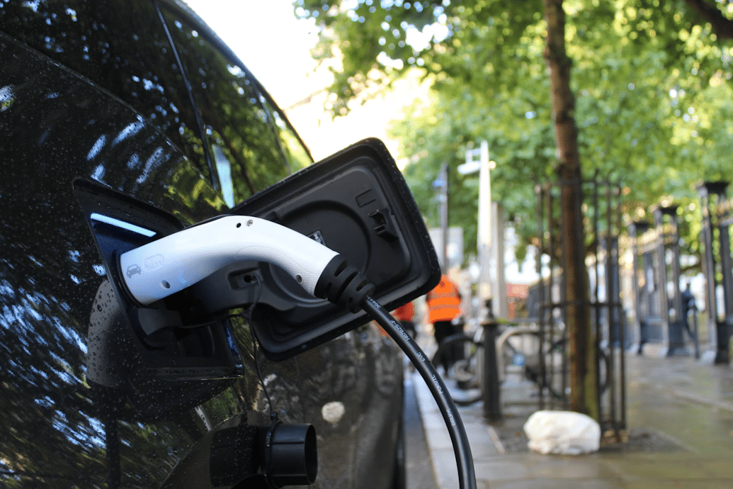 An electric vehicle plugged in for charging in Birmingham city centre.