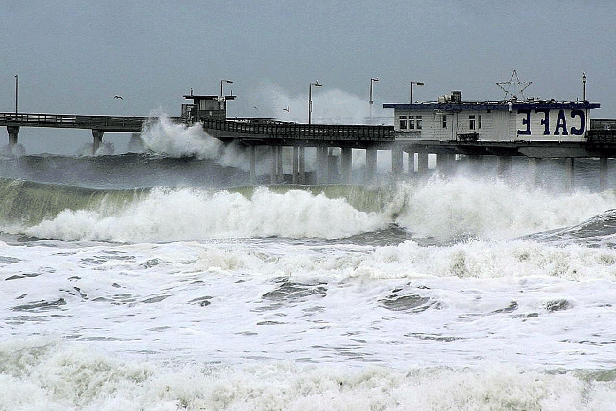 Waves of a stormy sea, crashing against a pier